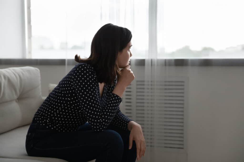 Woman deep thinking/wondering while gazing at sky